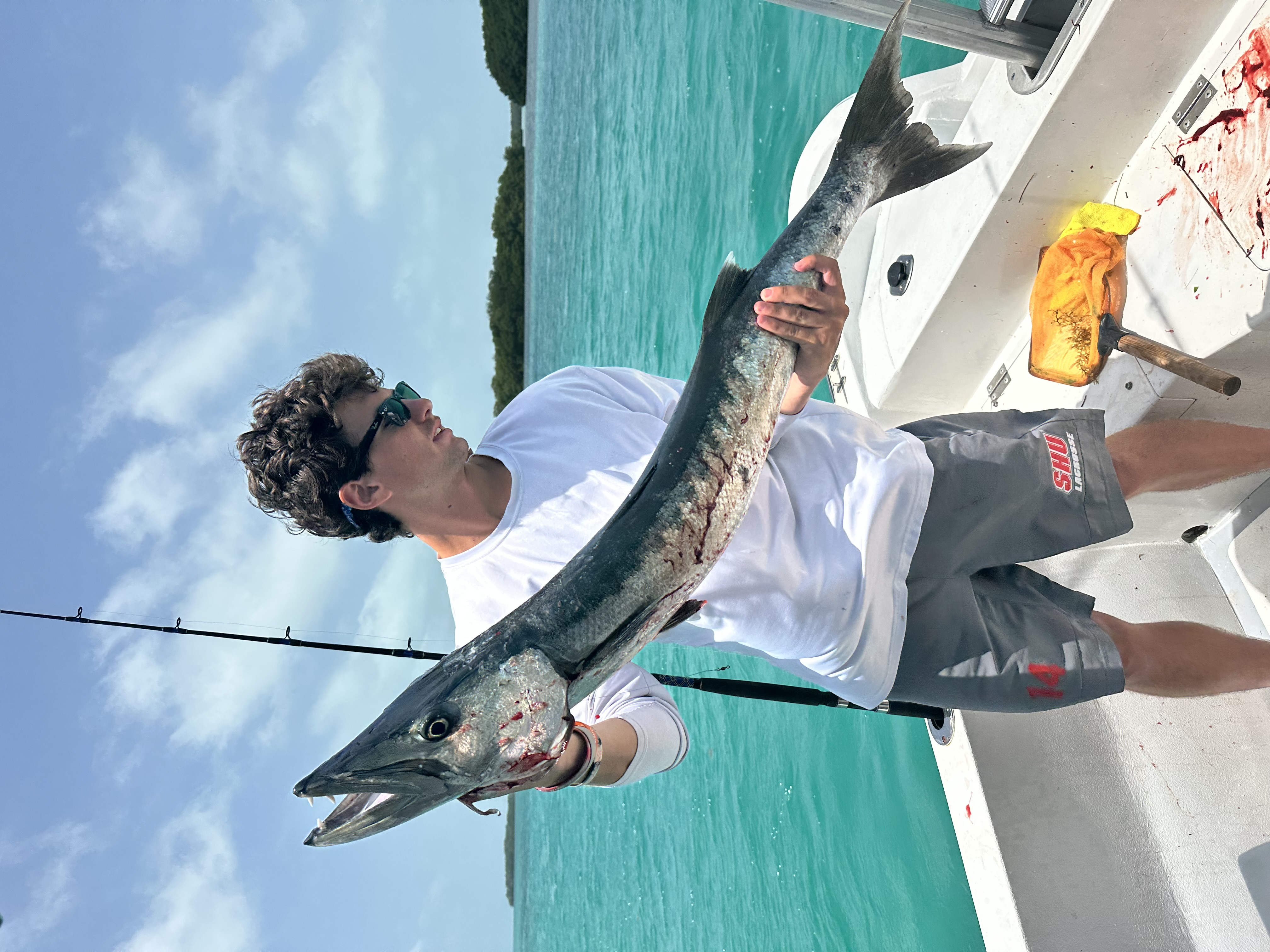 Close-up of a barracuda held up on board after a reef fishing trip